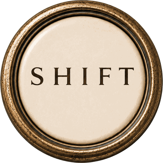 An antique brass typewriter key reading Shift